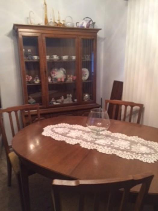 Dining room table with china cabinet and one leaf.
