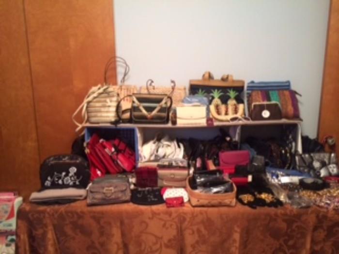 Fabulous collection of handbags, belts, coin purses and glass cases.