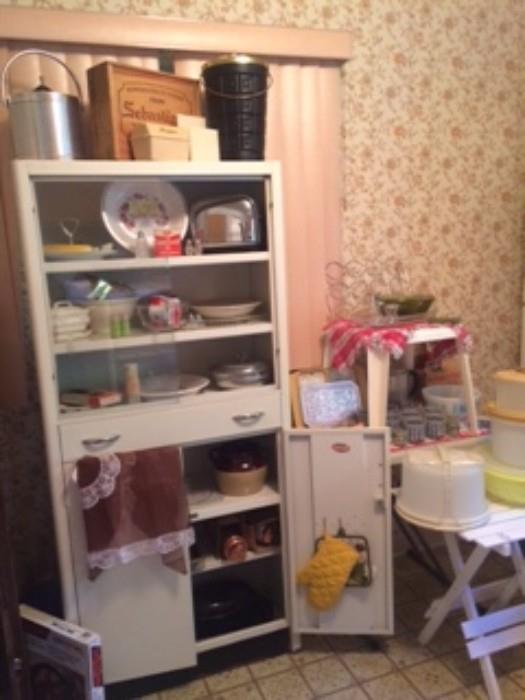 Metal kitchen cabinety with vintage kitchen item and tupperware