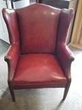 Red leather wing back chair