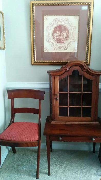 One of the set of 12 sabre-legged mahogany dining chairs, an antique mahogany side table and a mahogany repro 3-shelf hanging cabinet. 