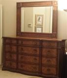 Drexel Heritage 12-drawer dresser with beveled mirror. Burlwood top and drawer fronts. 