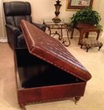 Michael Thomas from Robb & Stucky leather ottoman with nailhead trim is on castors. This shows the tufted top opened up for storage. 