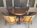 Pedestal dinette with 4 chairs on castors. Cushions are black & tan