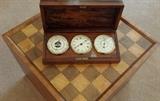 Rosewood aneroid barometer on a checkerboard end table