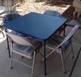 Meco card table and 4 upholstered folding chairs
