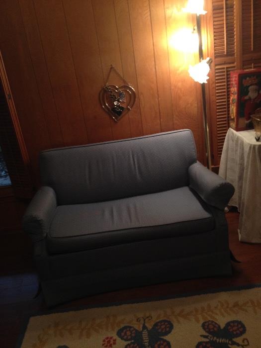 Loveseat with hidden sleeper sofa inside, blue fabric