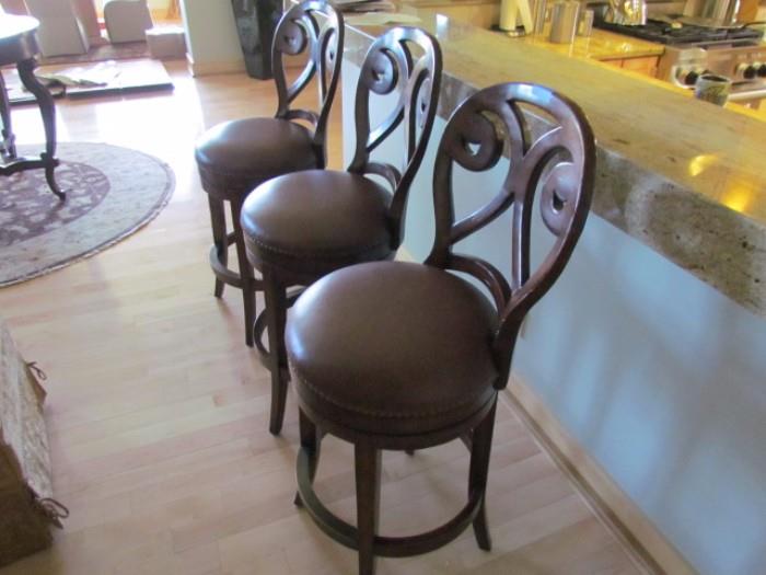 3 upholstered bar/counter chairs which swivel.