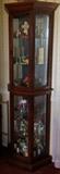 4 sided curio cabinet. Flat back with 3 angled sides. 70 x 20 x 11