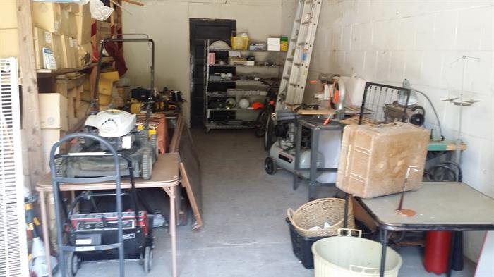 snow blower, lawn mower, metal ladder, metal shelf, sweing machine, dolly, bags, tools