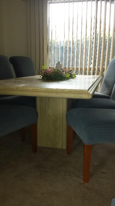 Travertine dining room table and velour upholstered chairs