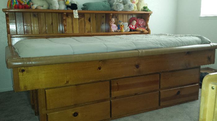 Pine bed with storage shelving, twin bed