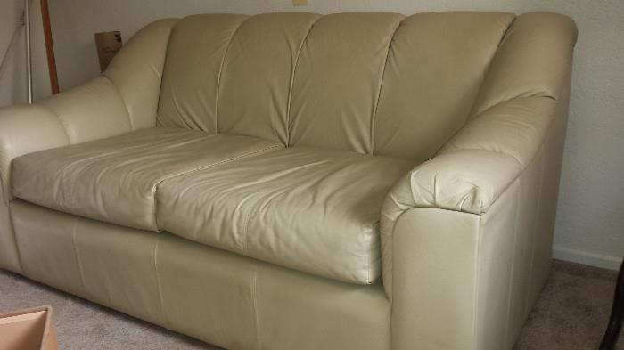 Leather love seats, ivory (one of two)