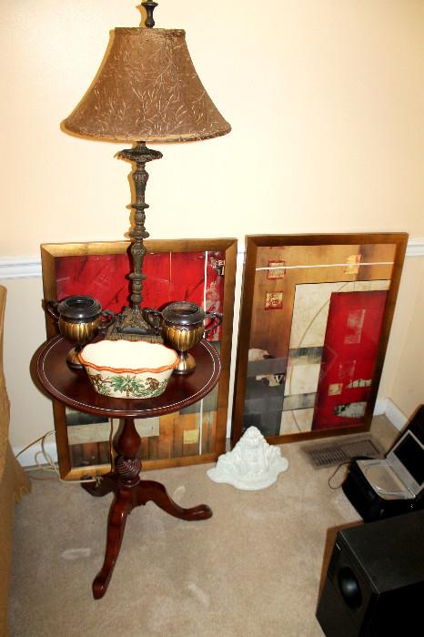 Small table with lamp, decor, and artwork