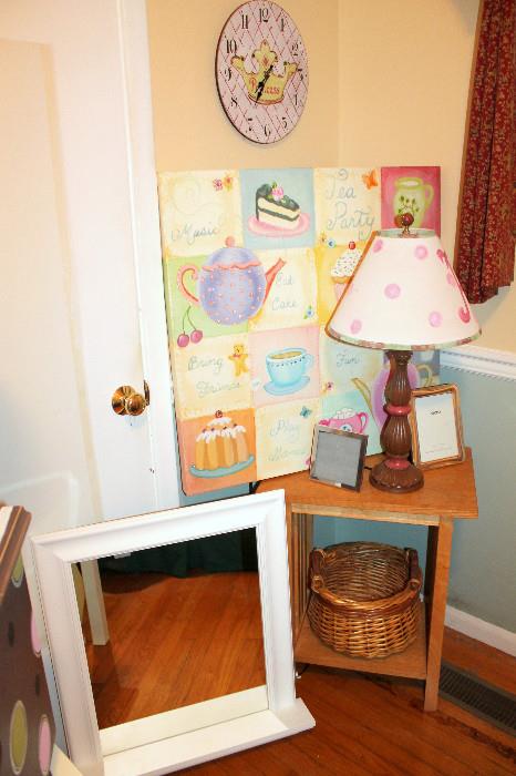 Nightstand, lamp, artwork, clock, and mirror