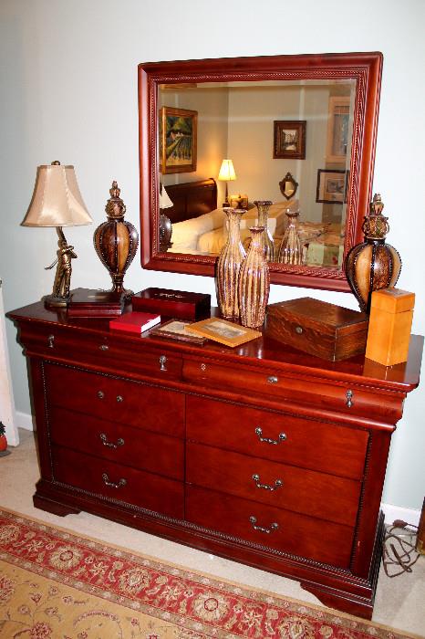 Dresser with mirror, lamp, and decor