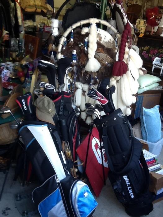 Lg dream catchers, golf bags with a variety of clubs.