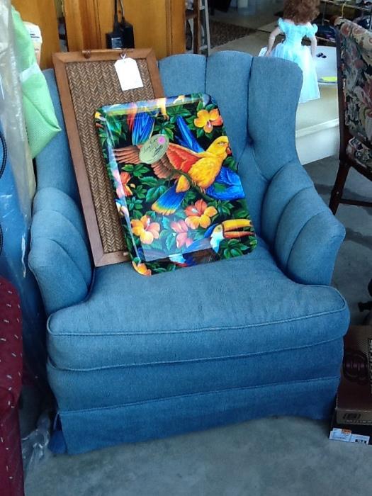 Blue upholstered chair, trays.
