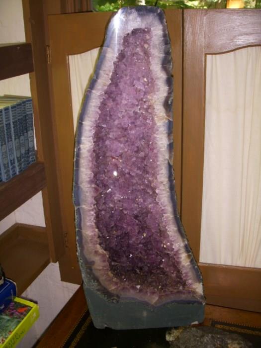 Huge amethyst specimen.  In foreground (barely visible) is a meteorite