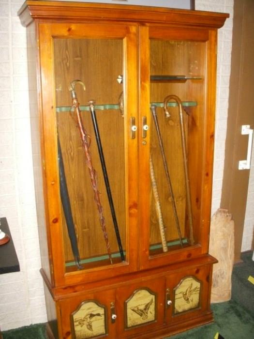 Gun cabinet displaying some of the cane collection. More photos of the canes are below