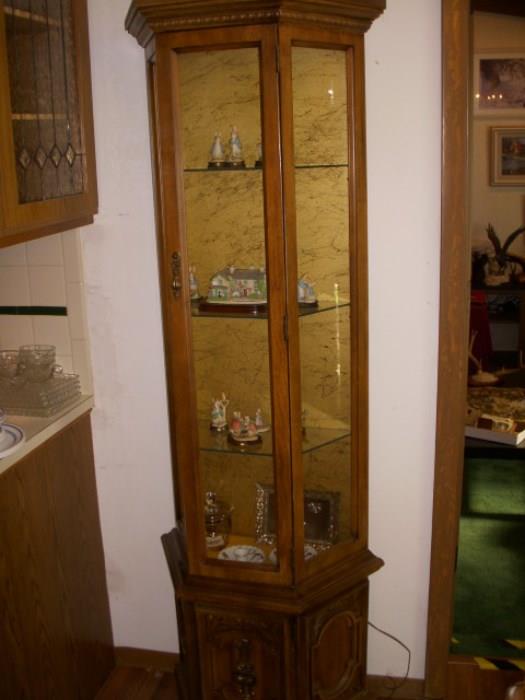 Lighted curio with figurines displayed
