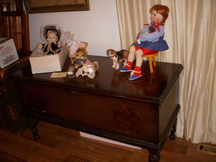 Cedar chest displaying newer collectible dolls