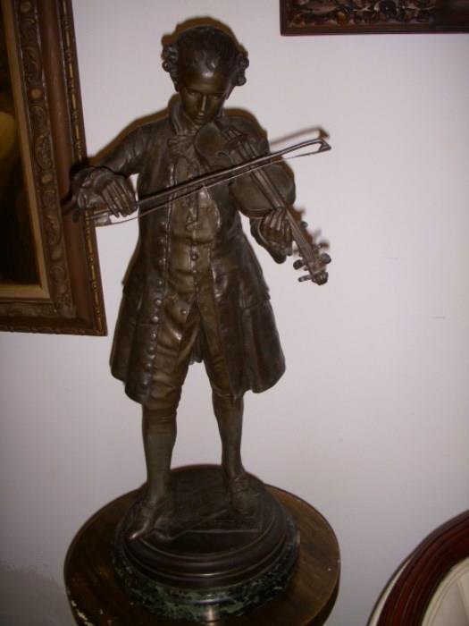 Cast figure of violin player.  Faux bronze finish over cast white metal, set on marble base