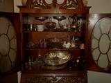 Heavily carved French walnut Secretary filled with Sterling serving pieces and Chotkies.