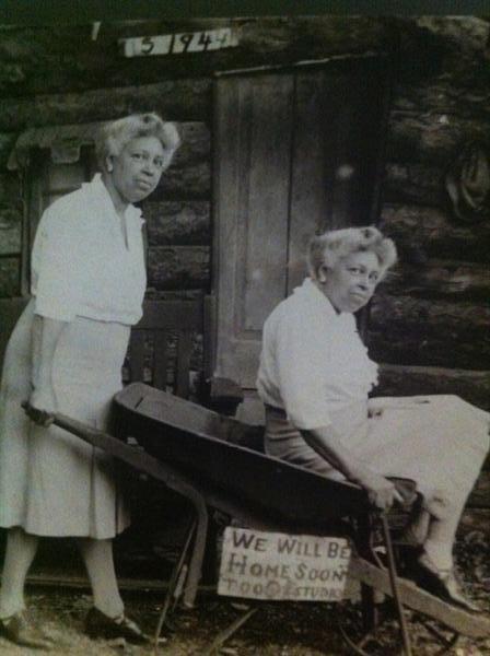 Extensive collection of turn of the century African American photographs. This photo despicts adult African American twin sisters and a wheel barrel.