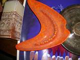 Orange "Boomerang" shaped ashtray.