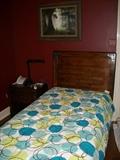 twin bed with lots of masculine decorator linens