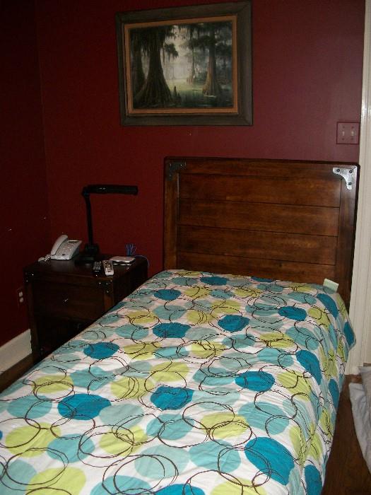 twin bed with lots of masculine decorator linens