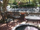 a whole patio filled with wrought iron furniture