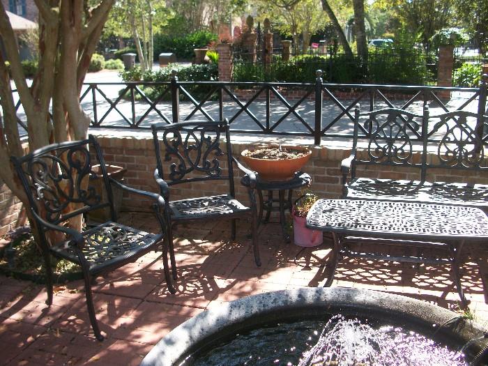a whole patio filled with wrought iron furniture