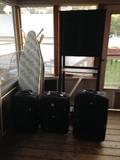 Luggage, bathroom cabinet, ironing boards.