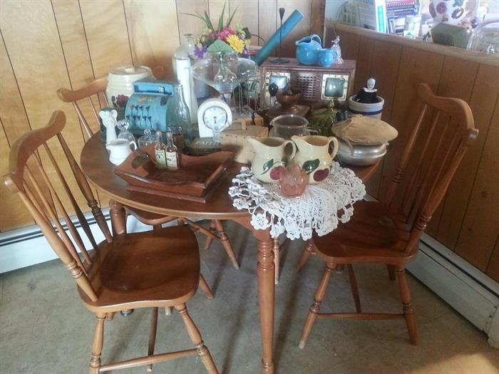 Round table and four spindle back chairs.  Table has one leaf.