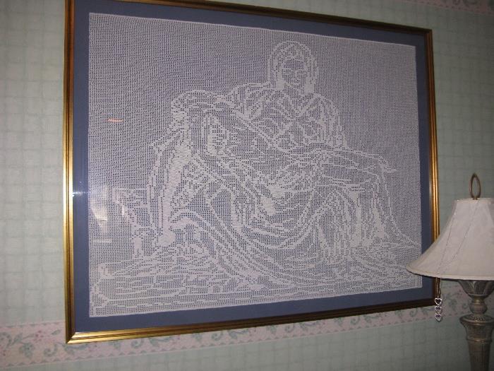 The Pieta crocheted by hand and framed under glass.