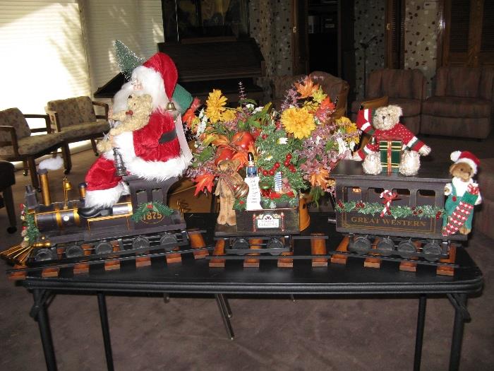 Santa rides an engine pulling a coal car and a passenger car and measuring over 4' total length.  Crafted by Karen Didion.  Includes 3 pieces of display track.