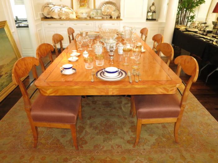 Beidermeier Pedestal Dining Table with Two Leaves & Eight Chairs, on an Antique Persian Rug; with an assortment of Fine China, Crystal and Silver.