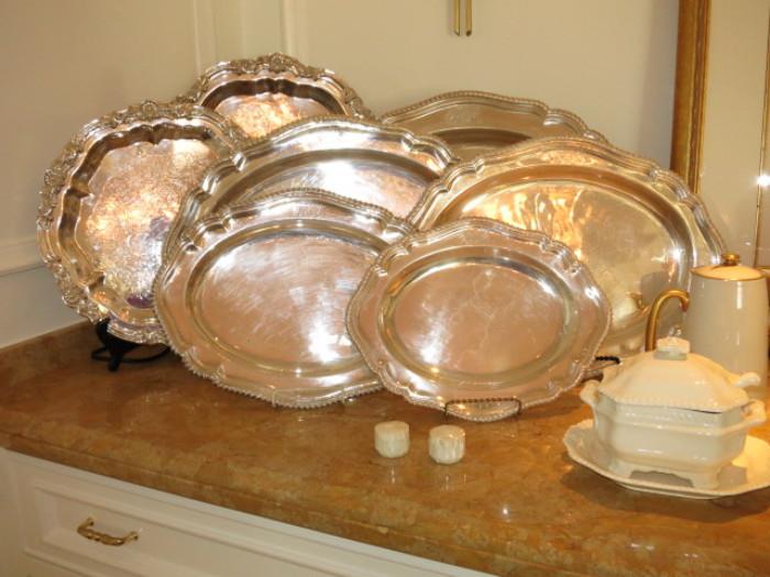 An assortment of Vintage and Antique Silverplated Serving Trays, including a Set of Five Graduated Trays with English Marks and Coat-of-Arms on the Rim.