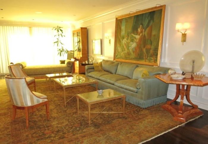 A Nine Foot Silk Sofa with a set of three Italian Mable-top Coffee Table inset on Gilt Bronze Bases; on a large Antique Persian Rug. 