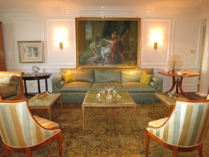 A Nine Foot Silk Sofa with a set of three Italian Mable-top Coffee Tables inset on Gilt Bronze Bases; a Pair of Beidermeier Sloping Armchairs on a large Antique Persian Rug. 