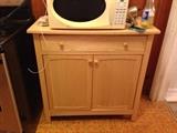 Blonde cabinet with top drawer and cabinet storage underneath.