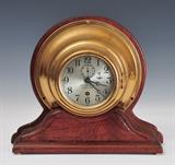 Lot #9: Tiffany & Co. Ship's Clock
 later mounted to oak stand 10 1/2" high overall, 3 3/4" face