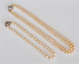 Lot#45: Two Pearl Necklaces
 one 18" double strand with pearls measuring 5 to 8 mm and one 15" single strand with pearls measuring 7 to 10 mm both with platinum and 14k gold clasps with inset sapphire circa 1925