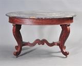 lot 70: Victorian Oval Marble Top Table
 with mahogany base and ripple molding 48" x 32", 30" high circa 1850