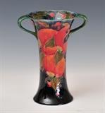 lot 145: Moorcroft Two Handled Vase
 Pomegranate pattern 8 3/8" high with green script signature early 20th century