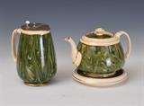 lot 152: William Moorcroft: MacIntyre Tea Pot
 together with under plate and milk pitcher Agateware pattern largest 6 1/2" high signed