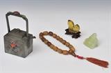 lot 205: Grouping of Chinese Artifacts
 including 6 1/2" pewter tea pot with inset stones, hard stone necklace with carved faces, small Buddha, and glass persimmon grouping