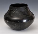 lot 242: Maria Martinez Pot
 black on black with water serpent motif 10" diameter, 8" high signed Maria/Popovi